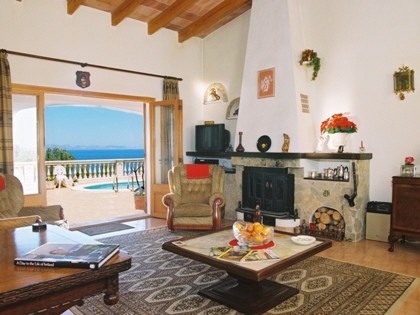 Blick in das Wohnzimmer mit Kamin und traumhaftem Meerblick.