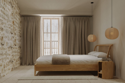 Gästezimmer mit Natursteinwand und warmen Leuchten – entspannte Rückzugsorte im Stadthaus von Alaró