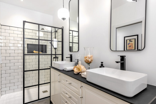 Stilvolles Badezimmer mit Doppelwaschbecken und Glasdusche