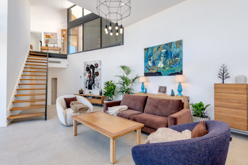 Double-height living and dining area with architectural volume
