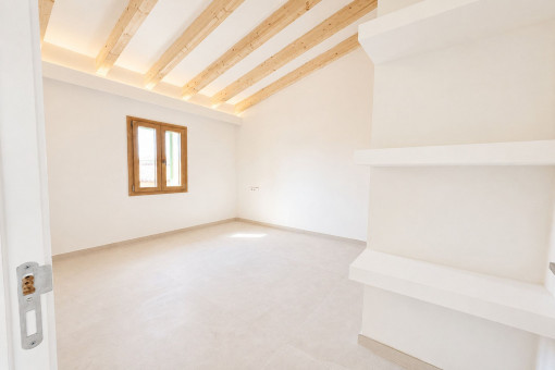 Schlafzimmer mit hohen Decken und sichtbaren Holzbalken