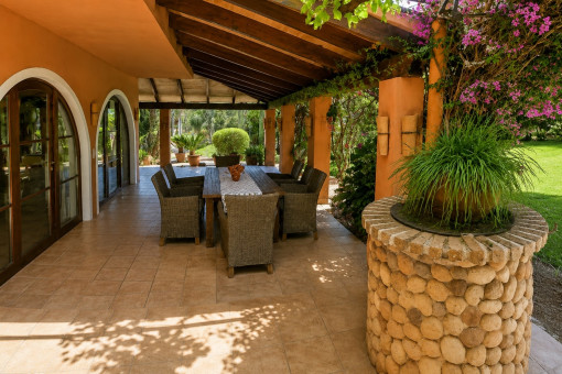 Überdachte Terrasse mit Essbereich und Gartenblick