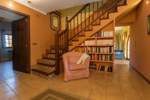 Gemütlicher Eingangsbereich mit Treppe und Bücherregal