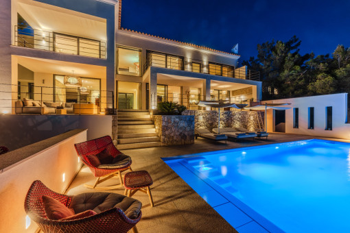 Stimmungsvolle Abendansicht der beleuchteten Villa mit Pool